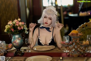 A woman in lingerie holding a plate of food.