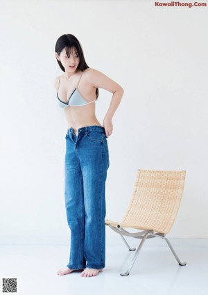 A woman in a blue jacket and shorts posing for a magazine.