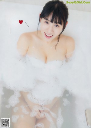 A woman in a red bra and panties posing for a magazine.