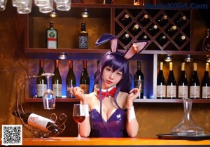 A woman in a bunny costume sitting on a bar.