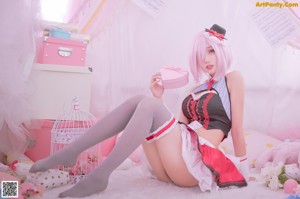 A woman in a maid outfit posing for a picture.